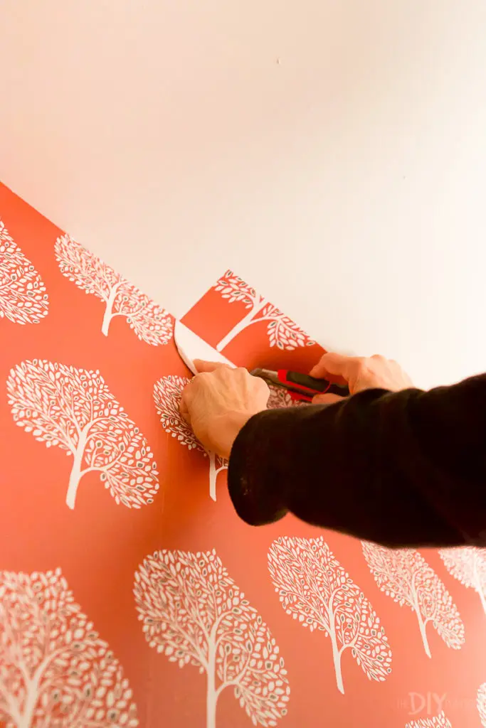 Applying more peel and stick wallpaper strips