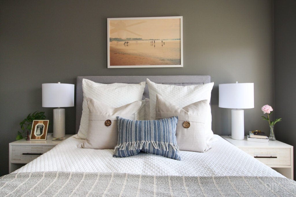 Creating a coastal bedroom with blue accessories and beachy art