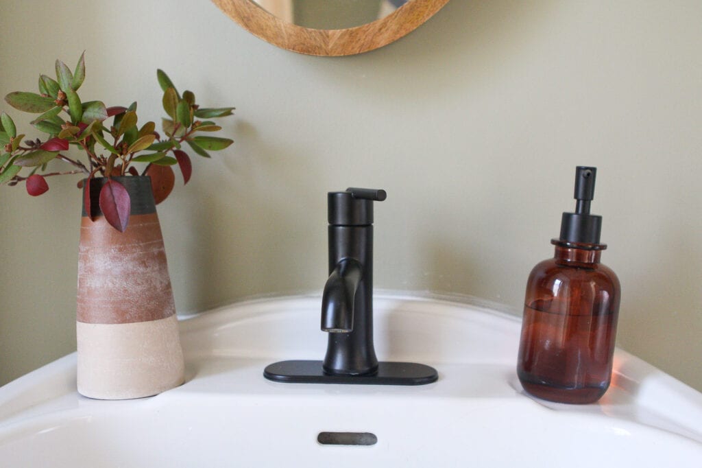 Black faucet with sink accessories
