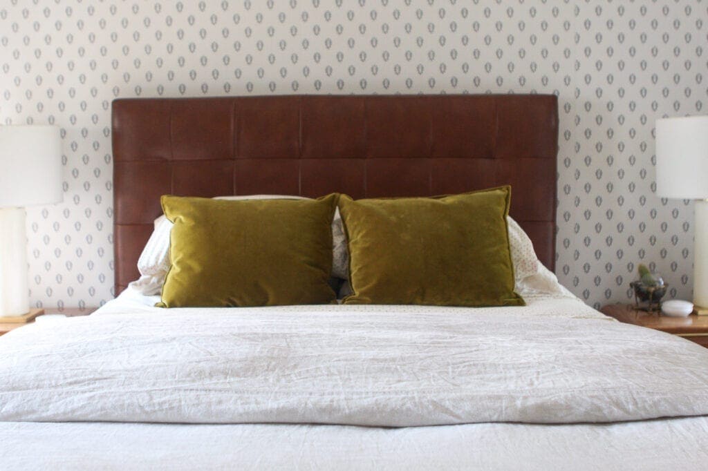 Olive green pillows on a bed