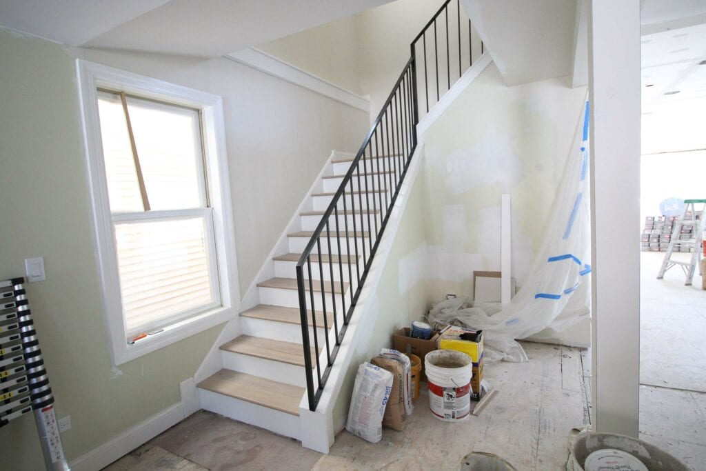 Stairwell transformation with metal railings and painted risers