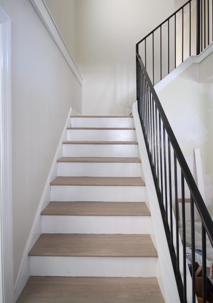 Wood oak treads and white risers on a stairwell transformation