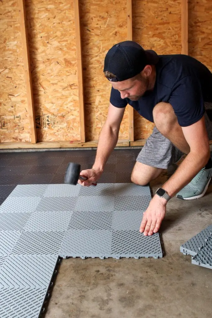 Finn laying garage floor tiles