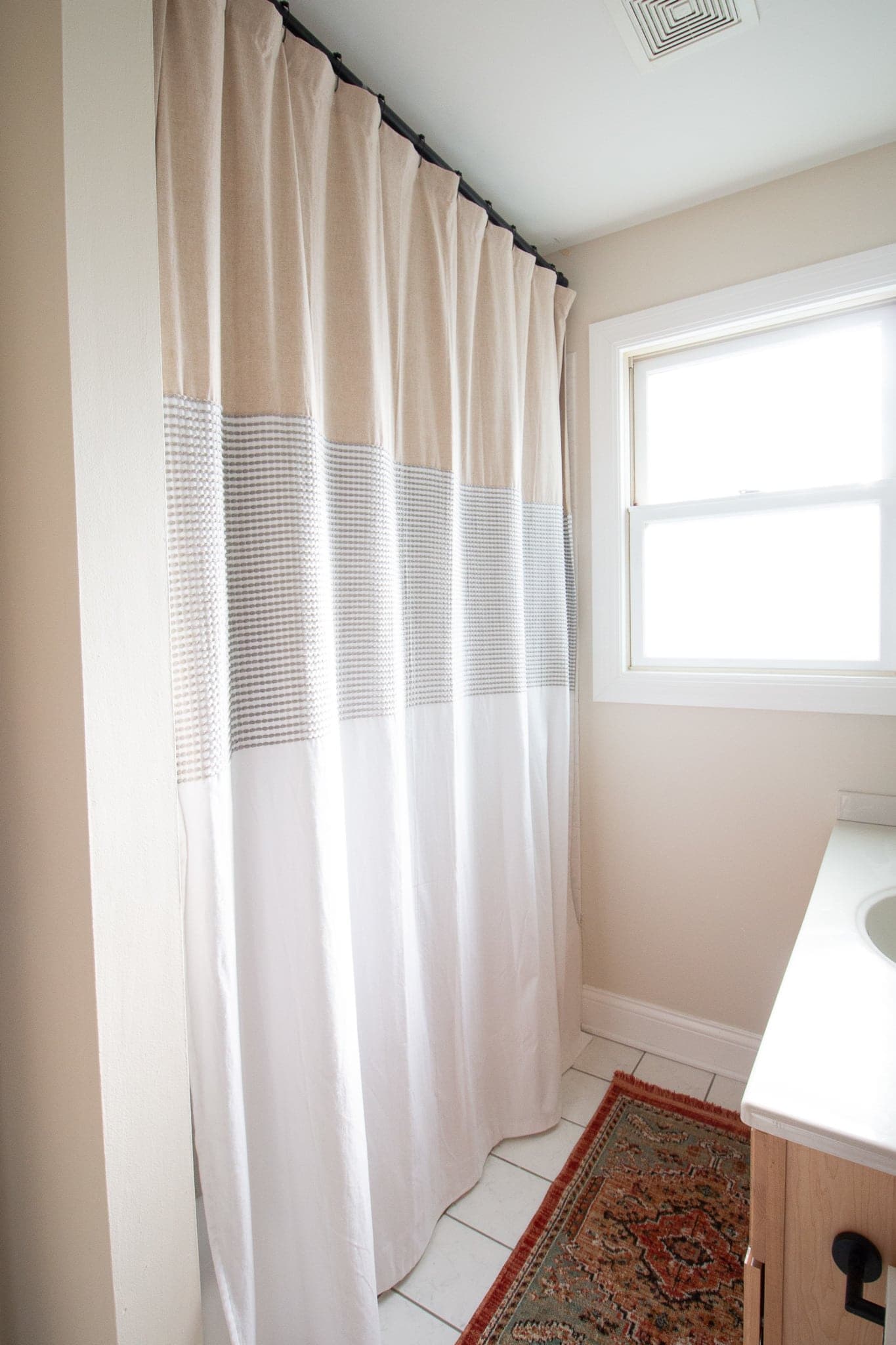 Use an XL shower curtain to hide ugly shower tile