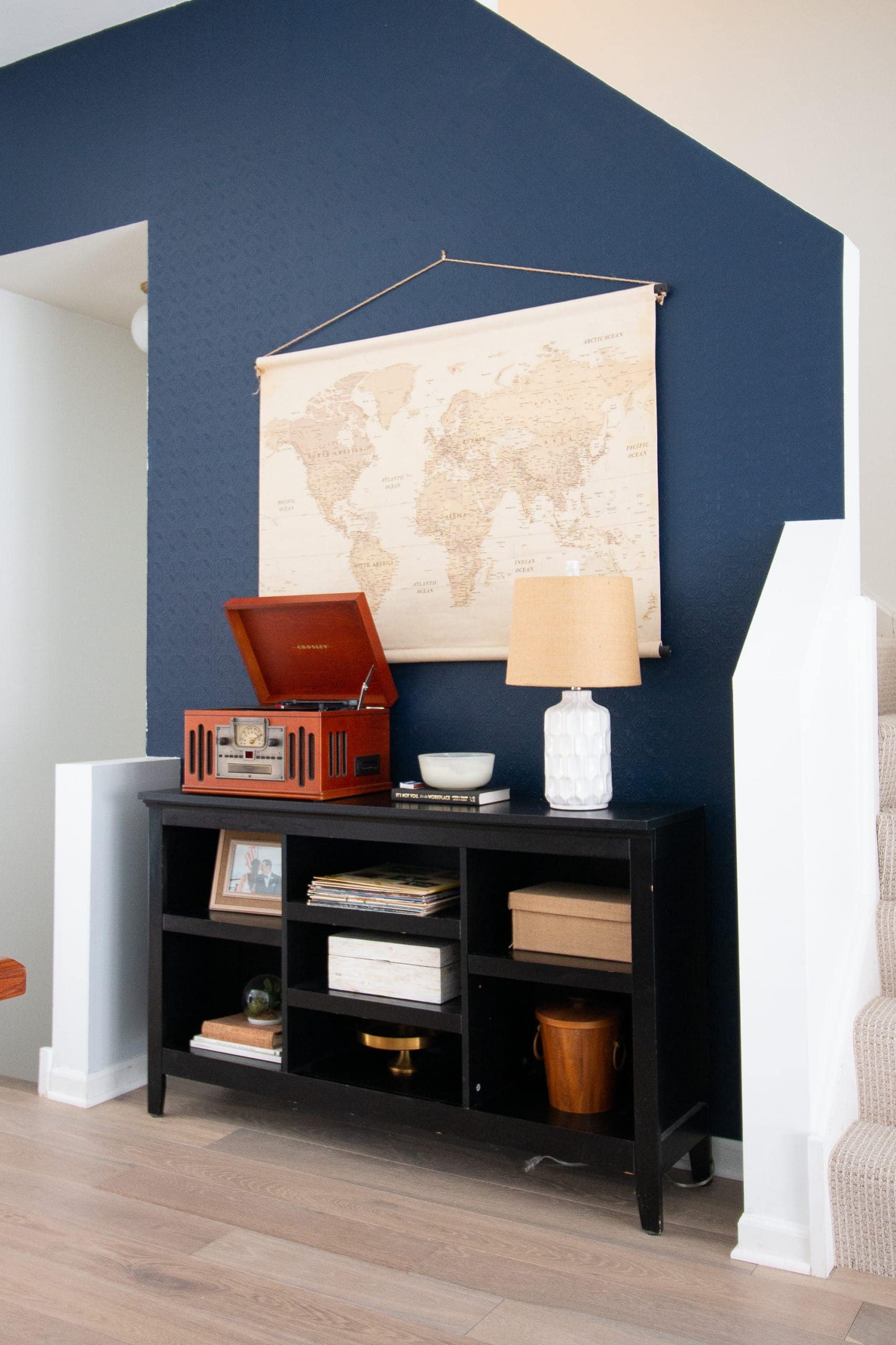 Dark blue accent wall with wallpaper