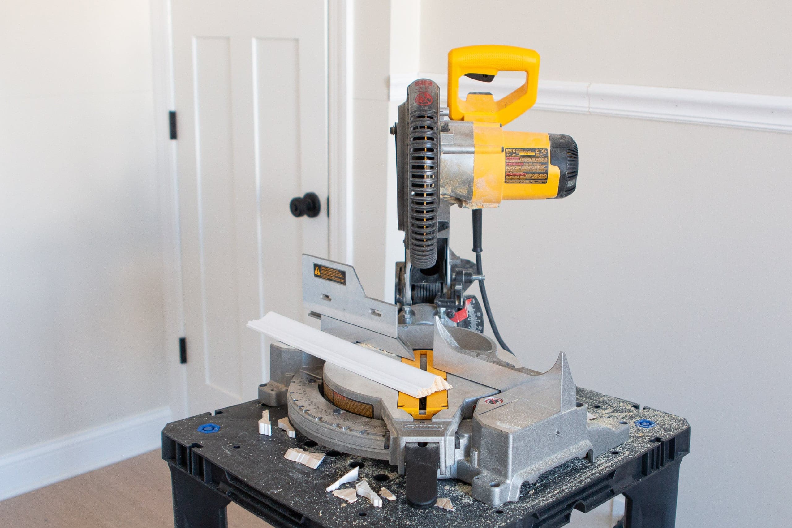 Using a miter saw to cut wood for chair rail