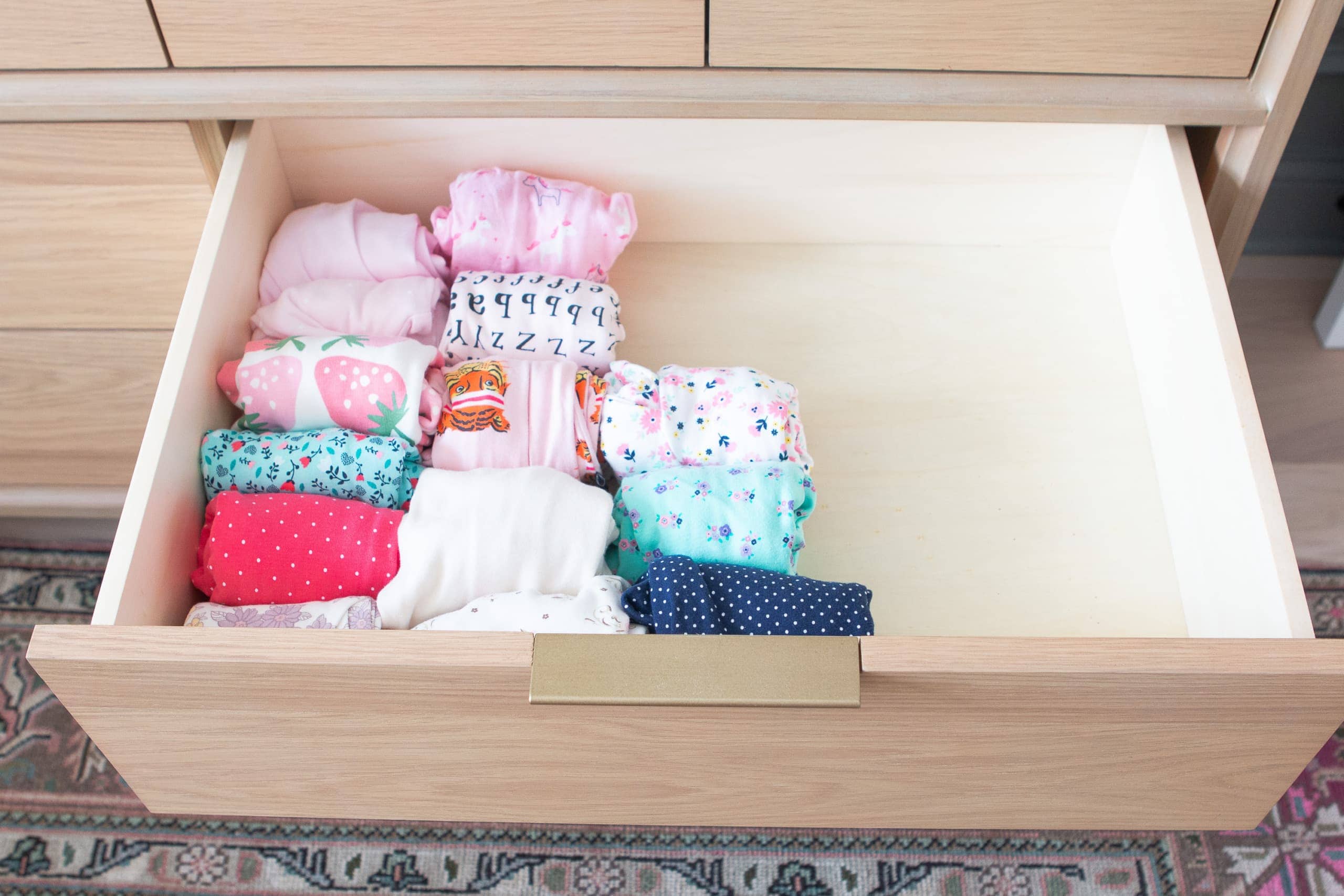 Adorable sleepers in a nursery dresser