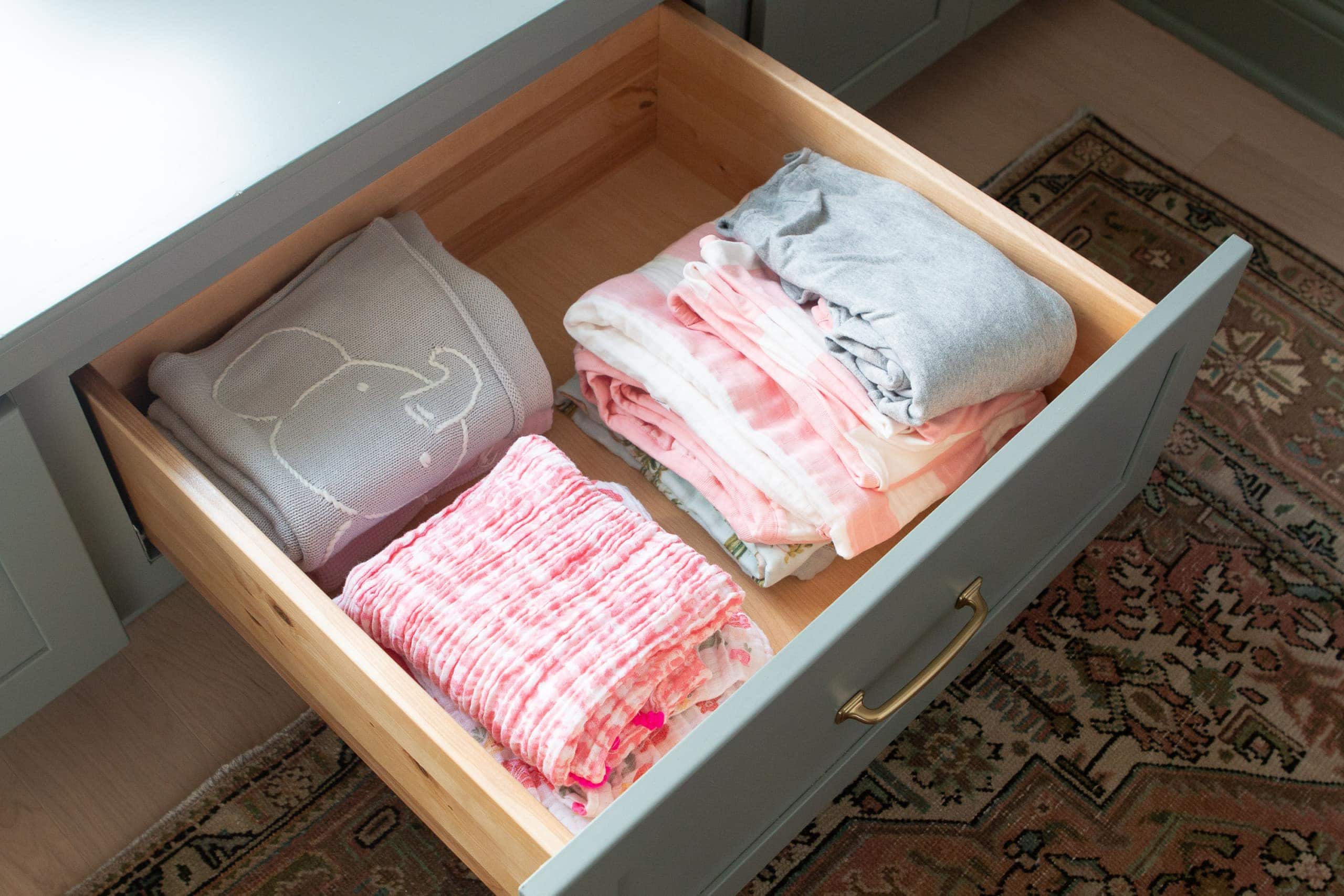 Extra blankets in a pull-out drawer in the nursery