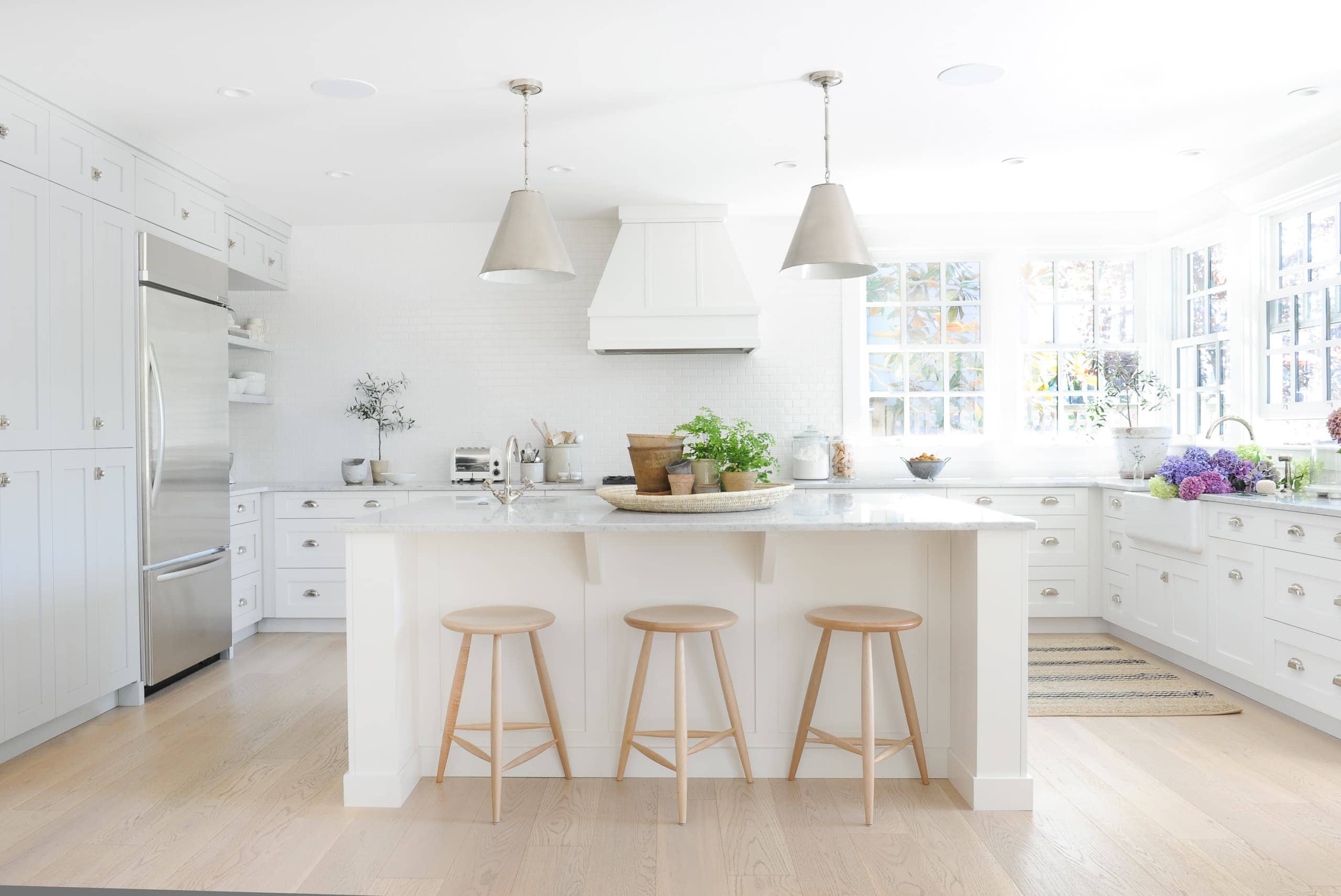 White kitchen with large island and white subway tile