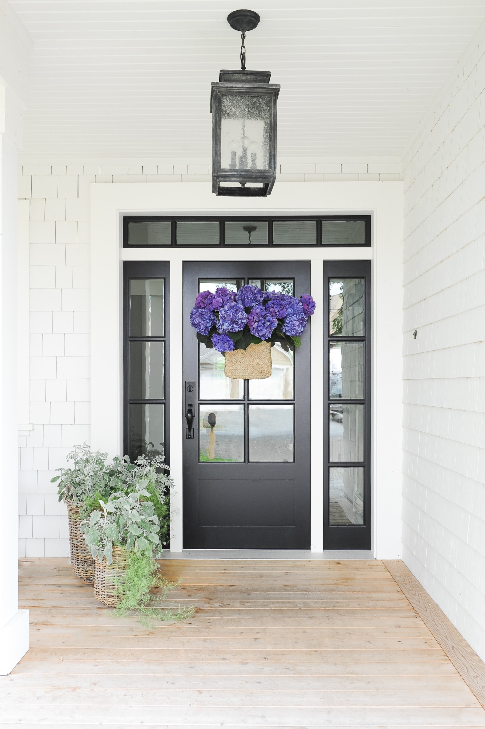 Black front door with white siding
