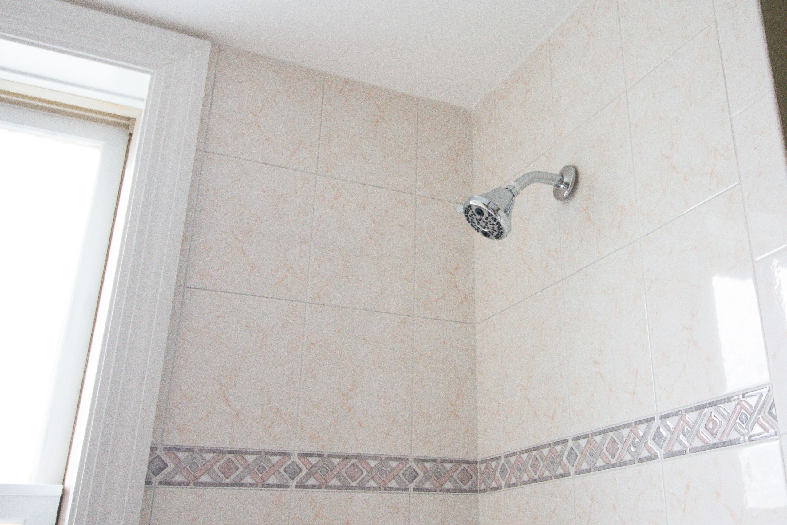 outdated shower fixtures with old shower tile
