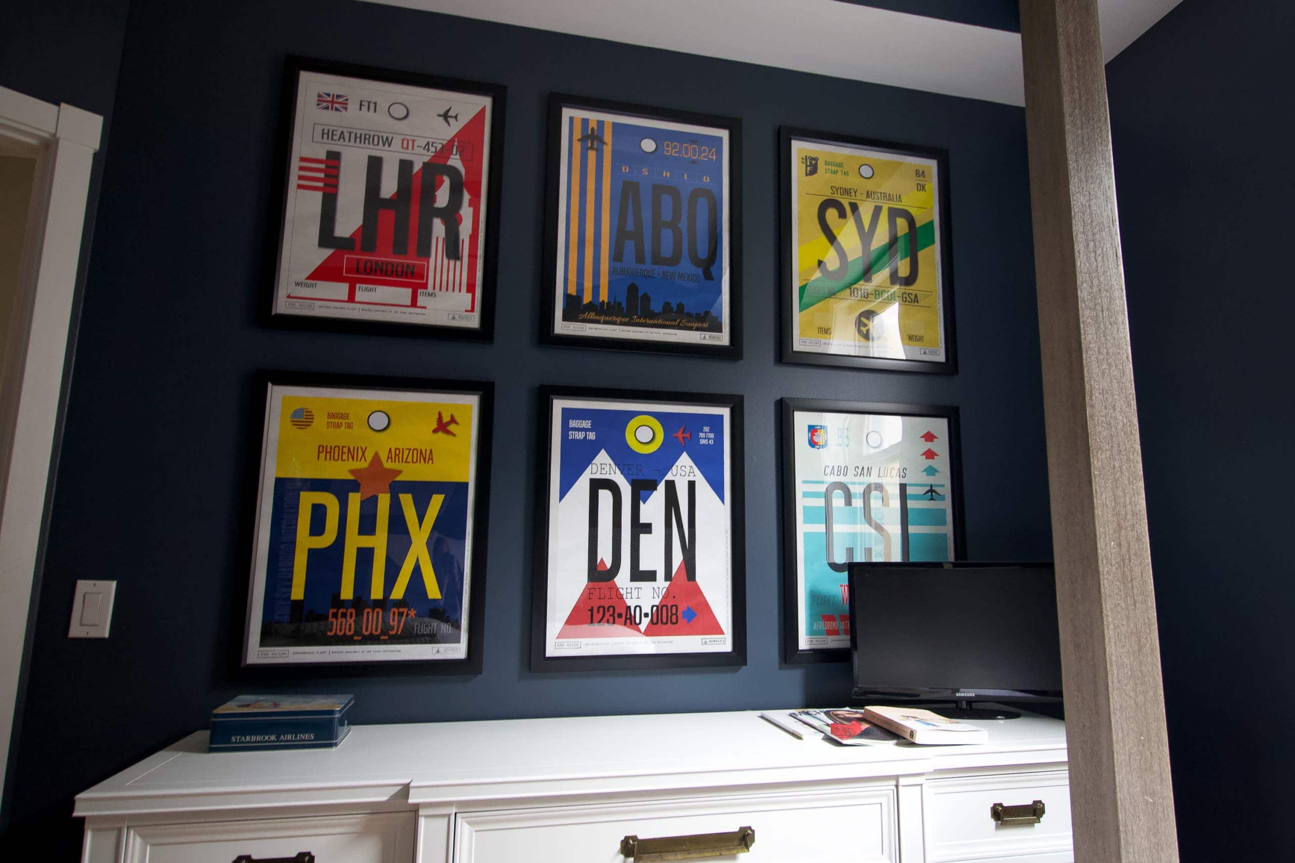 Guest room gallery wall with travel theme