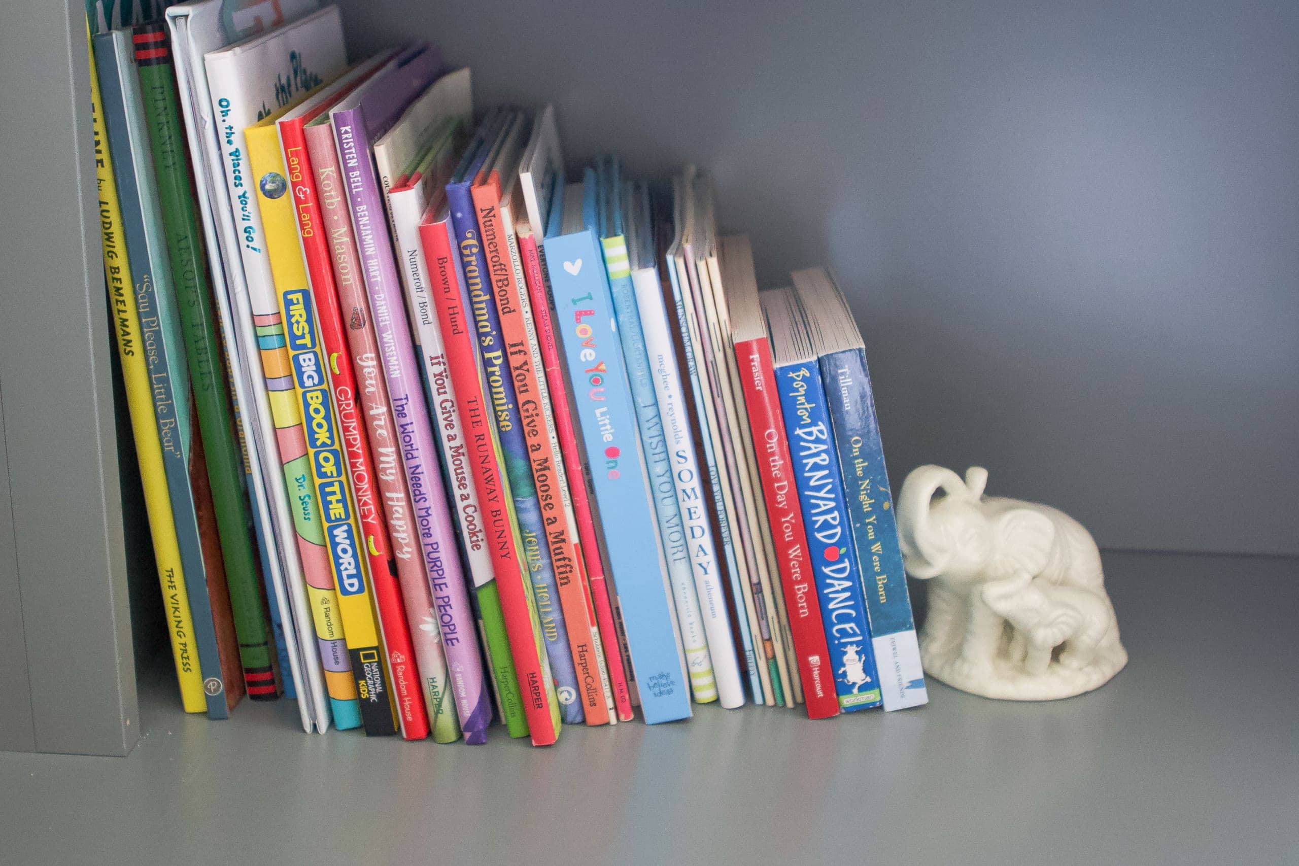 Display books both horizontally and vertically on nursery shelves