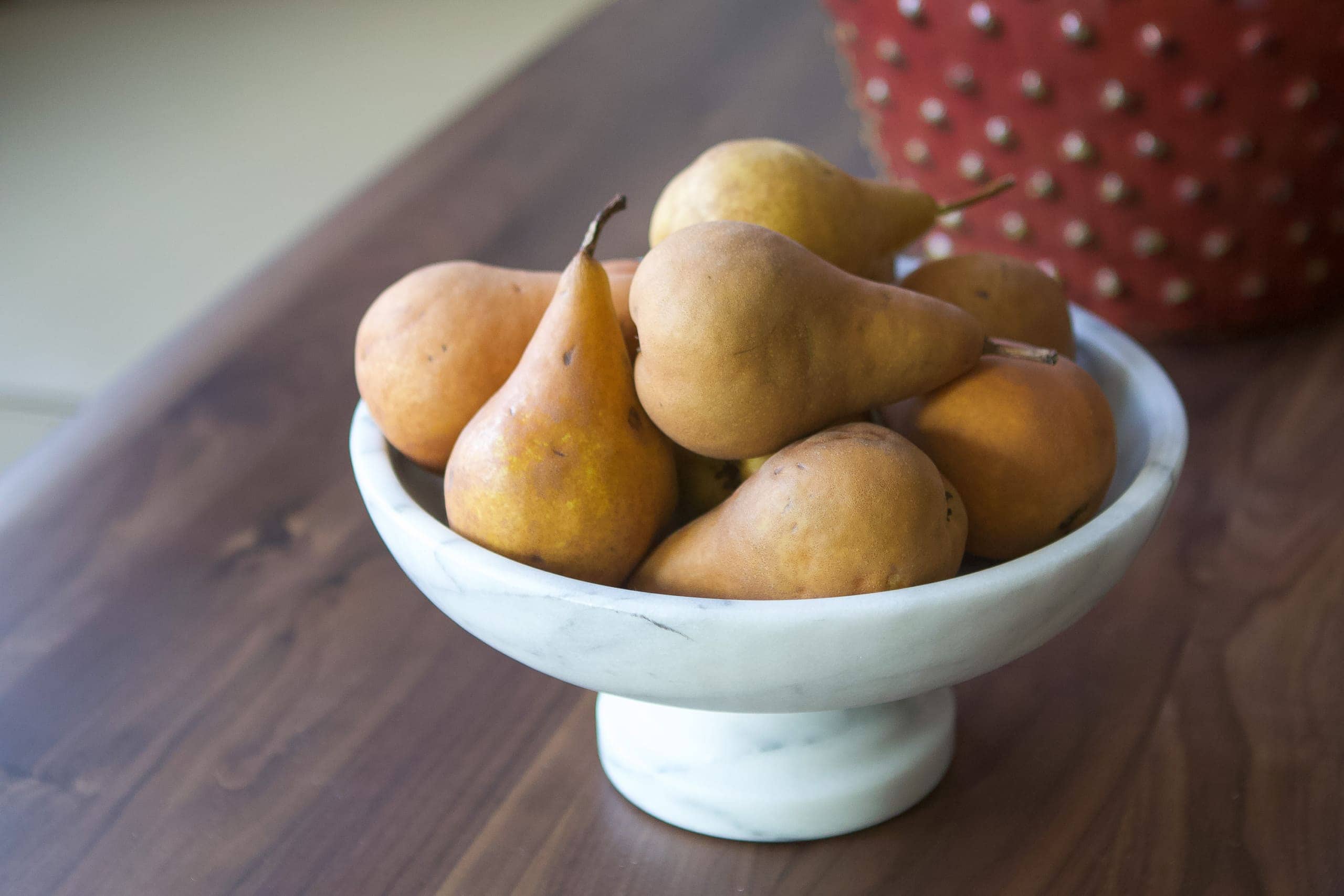Adding decorative pears to the dining room table
