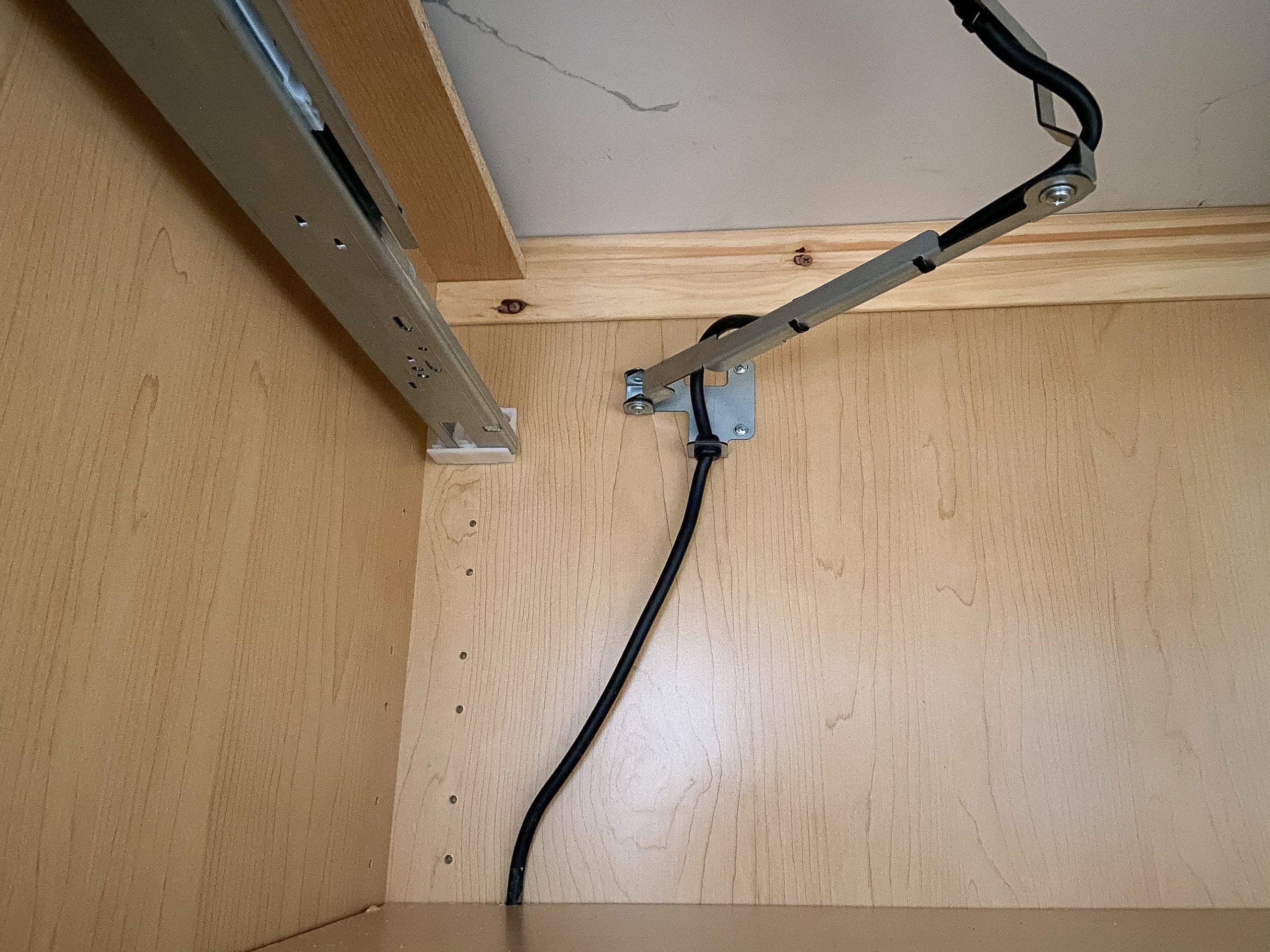 Mounting bracket beneath the charging drawer