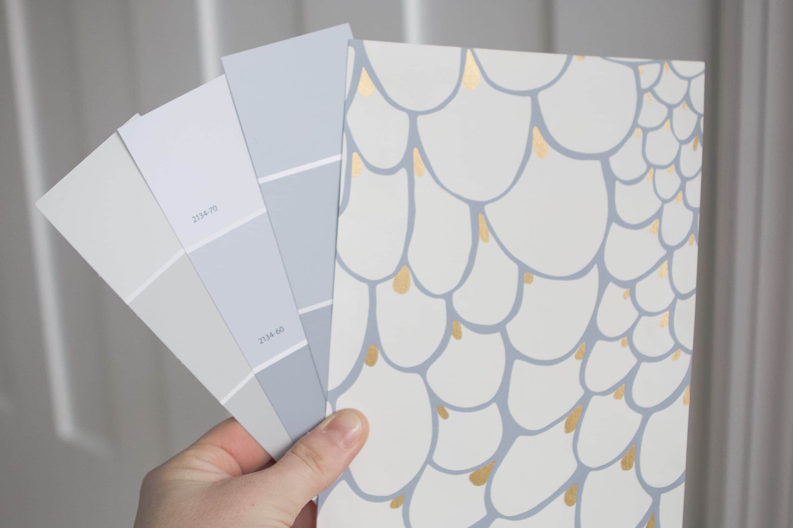 Putting the blue gray paint samples next to the wall paper