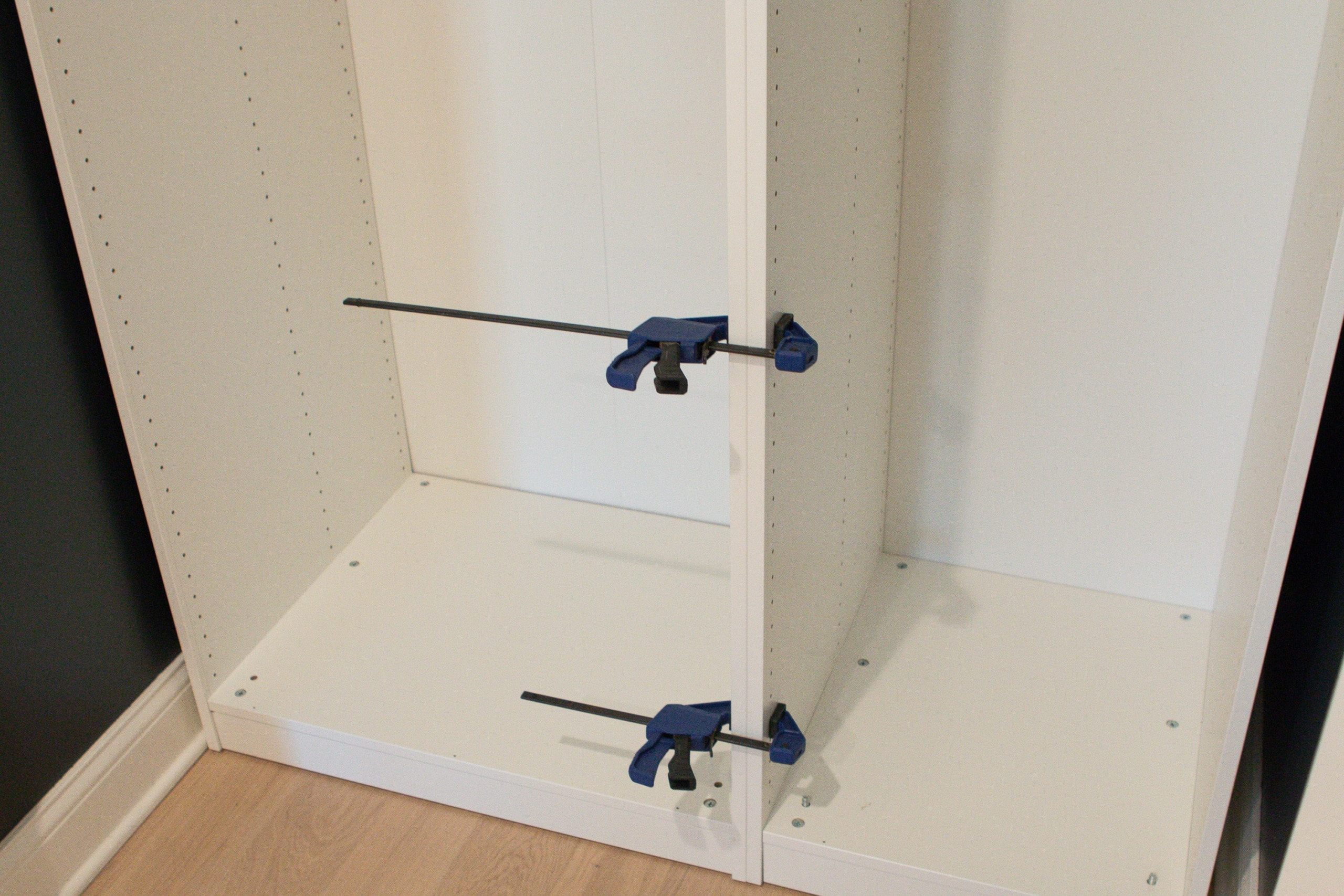 Use clamps to attach the two ikea pax wardrobes together