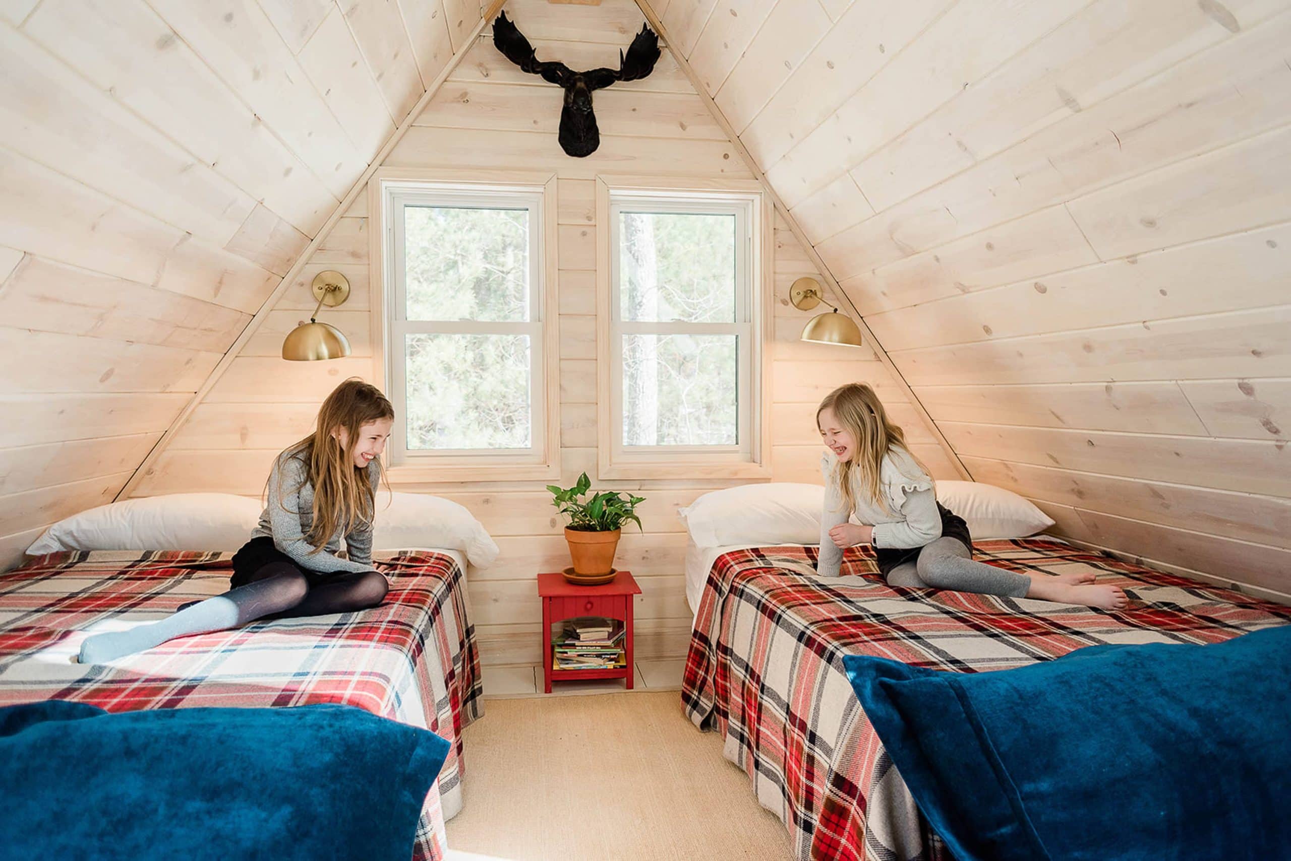 The girls enjoying their loft in their a-frame cabin