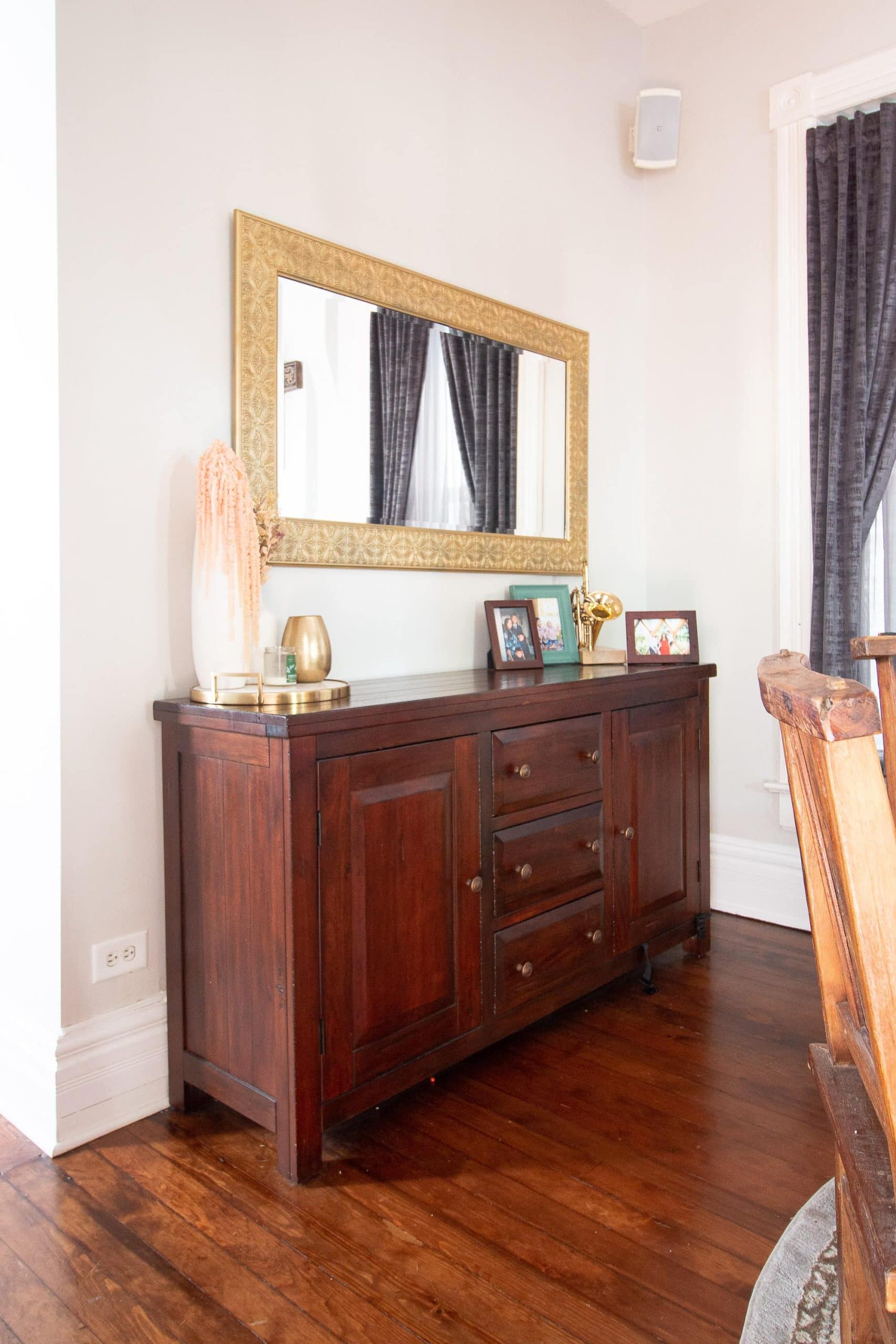 Wood sideboard with brass mirror above