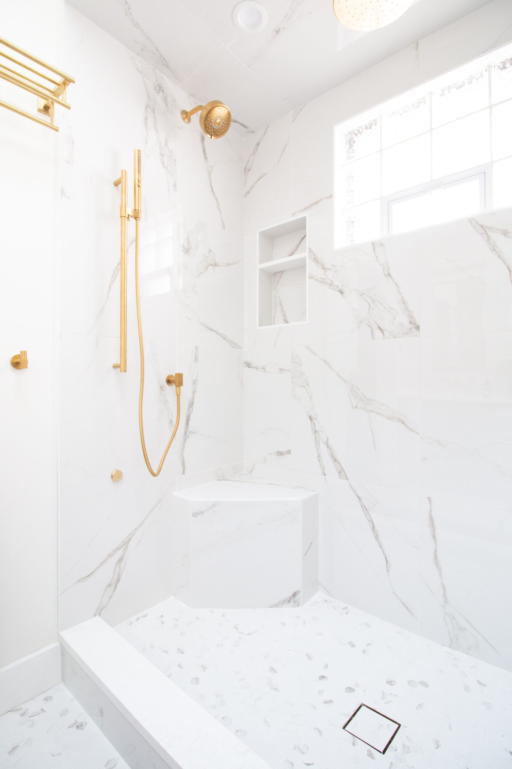 Marble shower with brass shower hardware