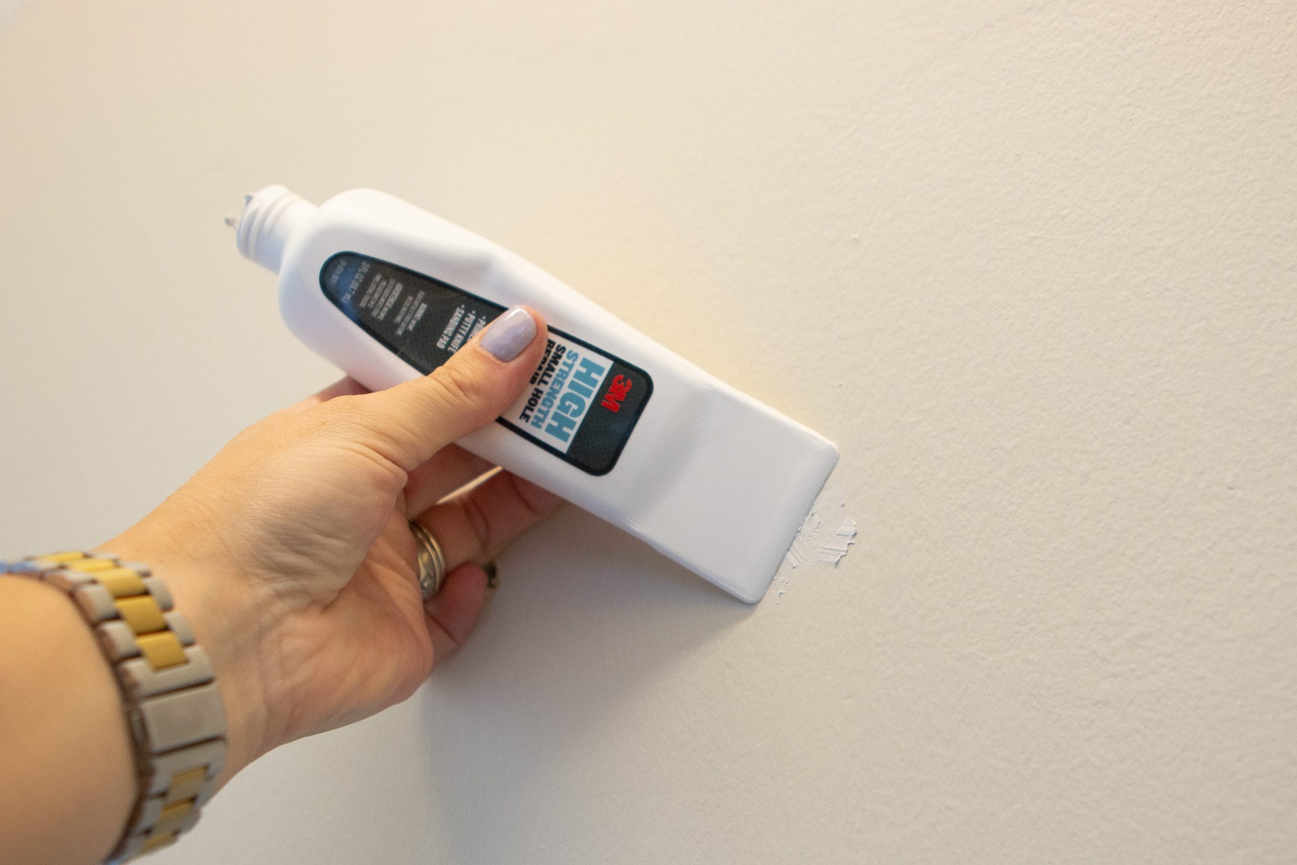 Use a putty knife to spread the spackle