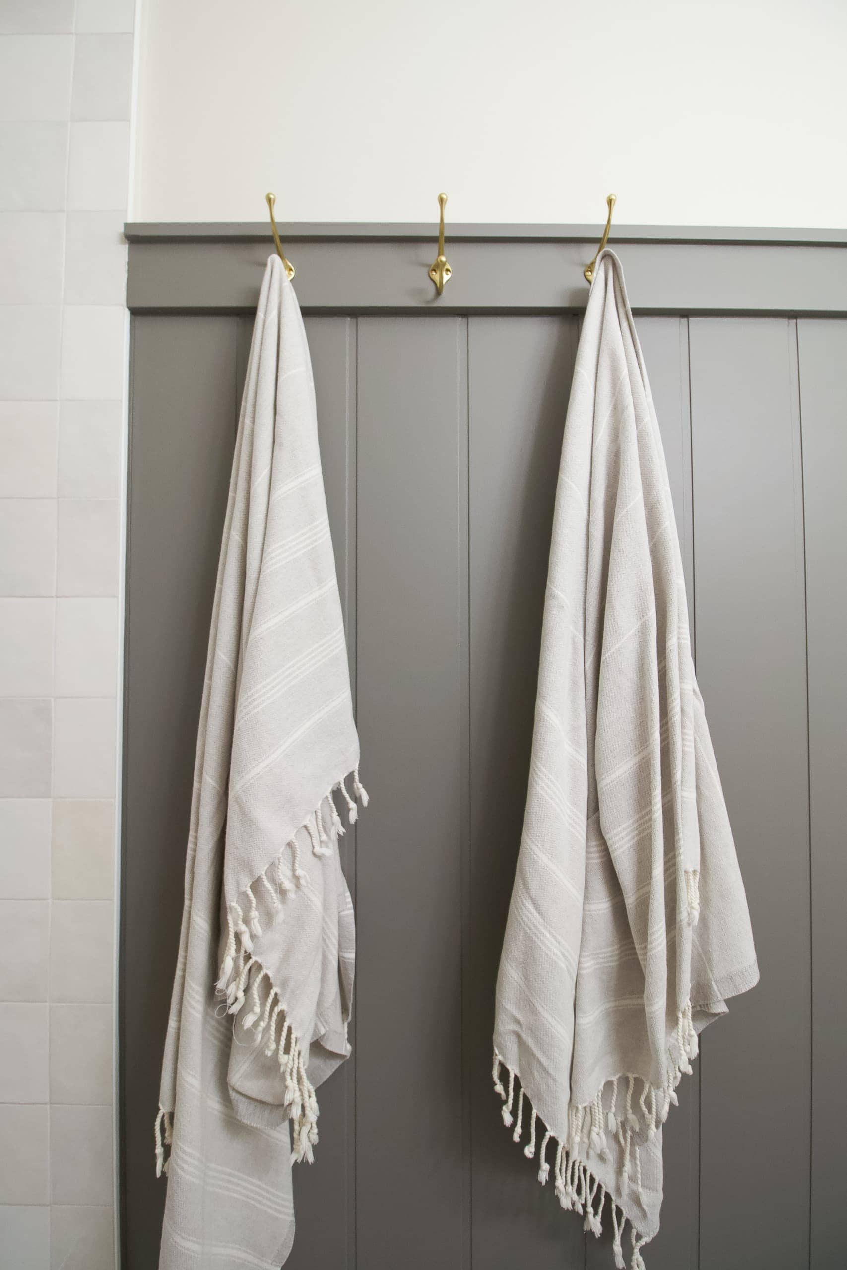 Turkish towels on hooks in a bathroom