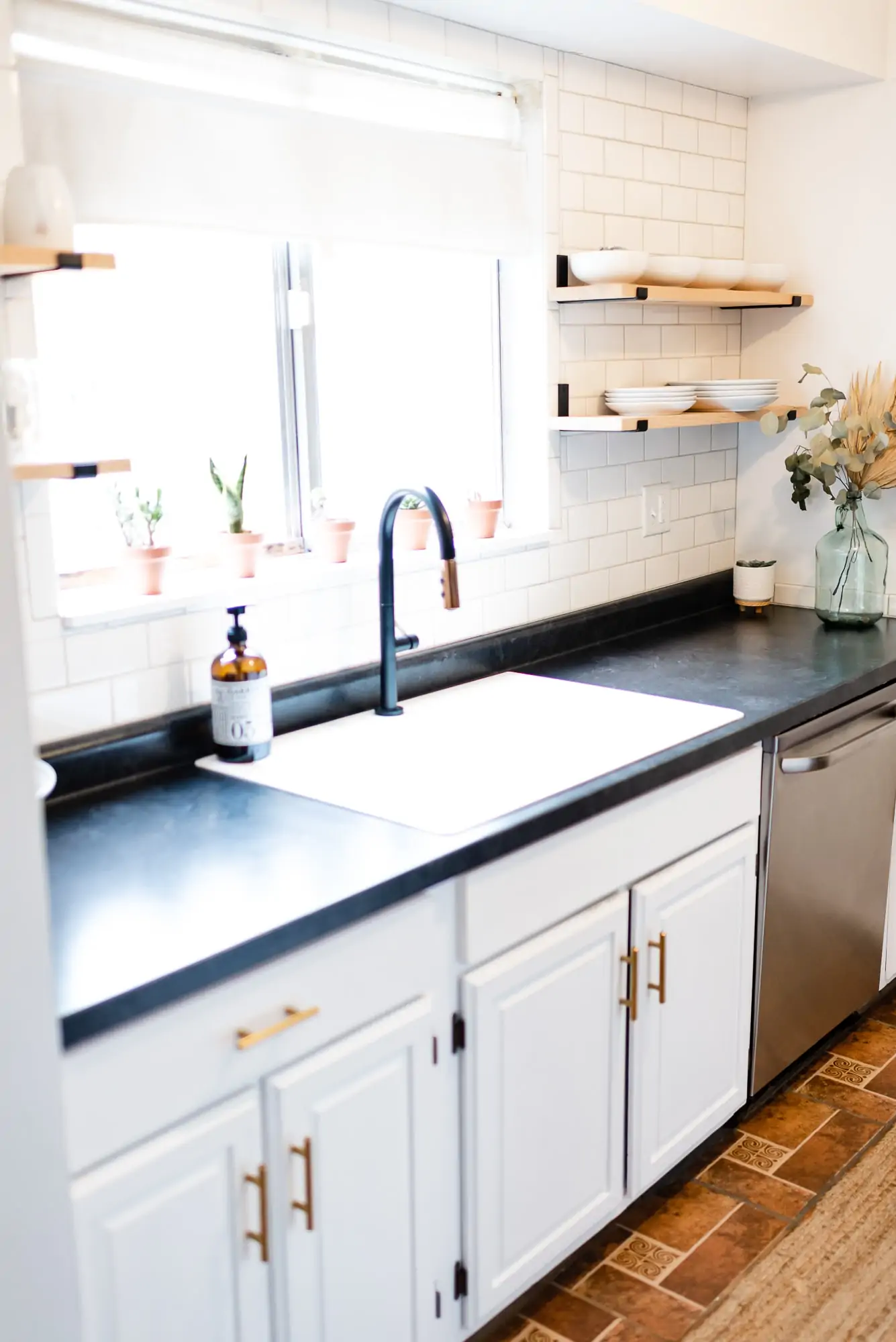 galley kitchen with a sink and black matte faucet 