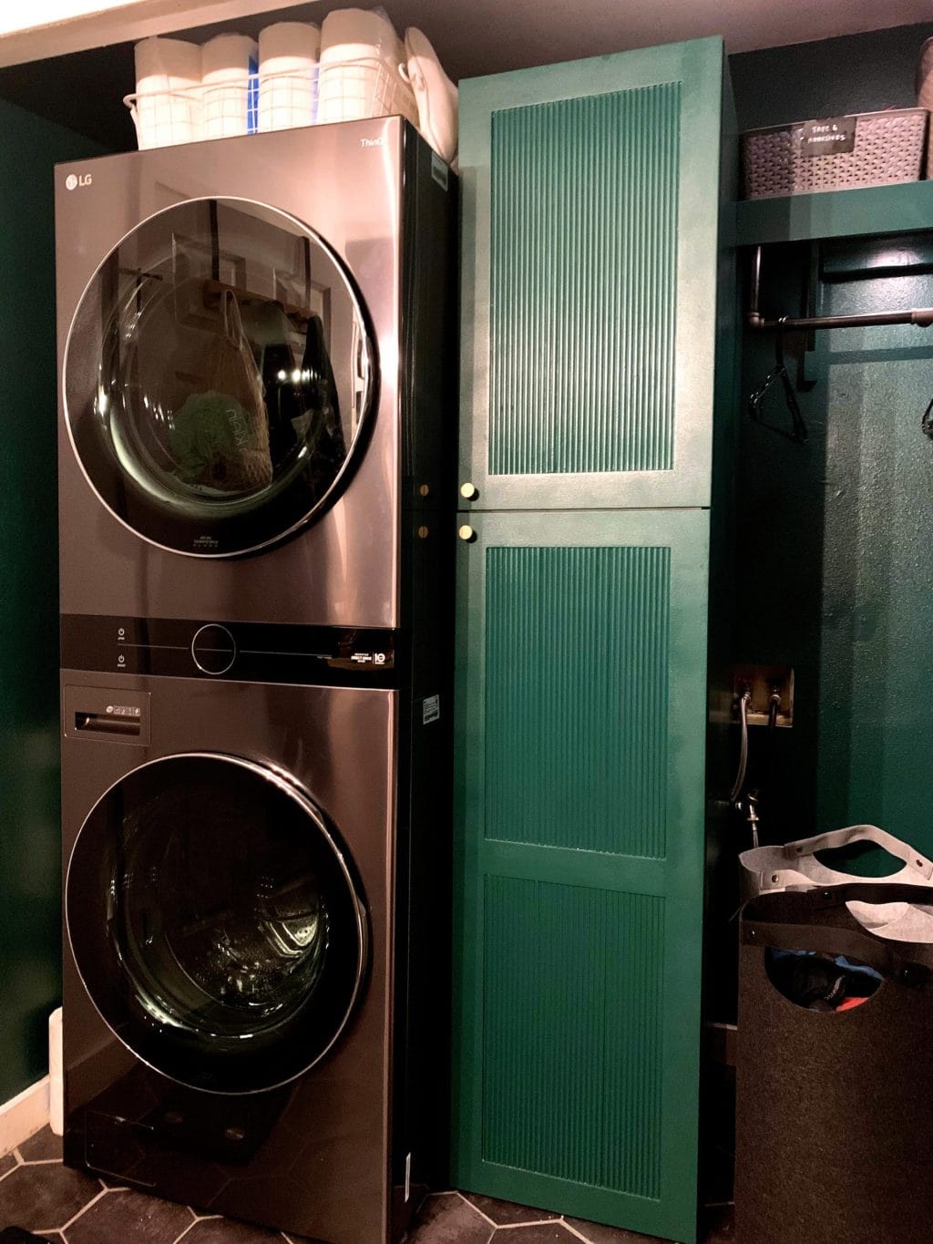 laundry room in a bathroom with green cabinets