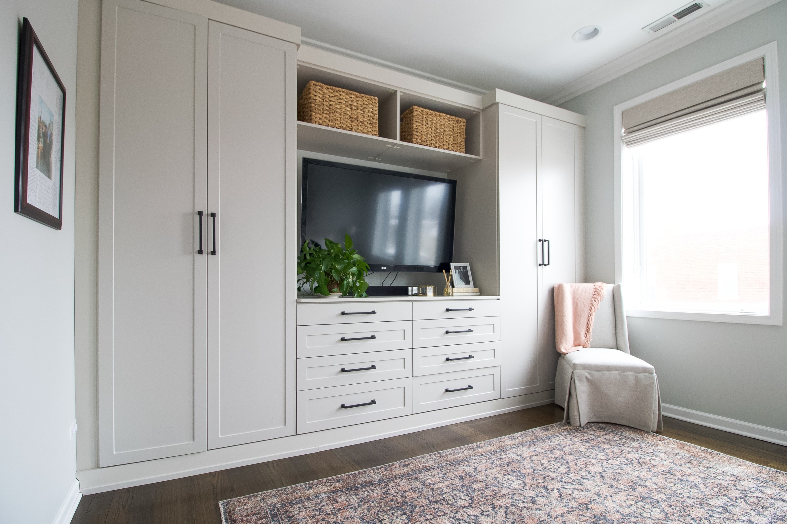 A wall of built-ins in this main bedroom makeover