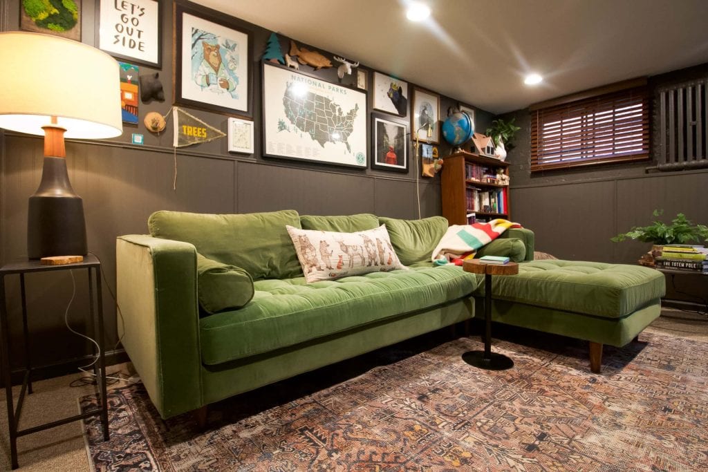 Green velvet sofa in a basement lounge