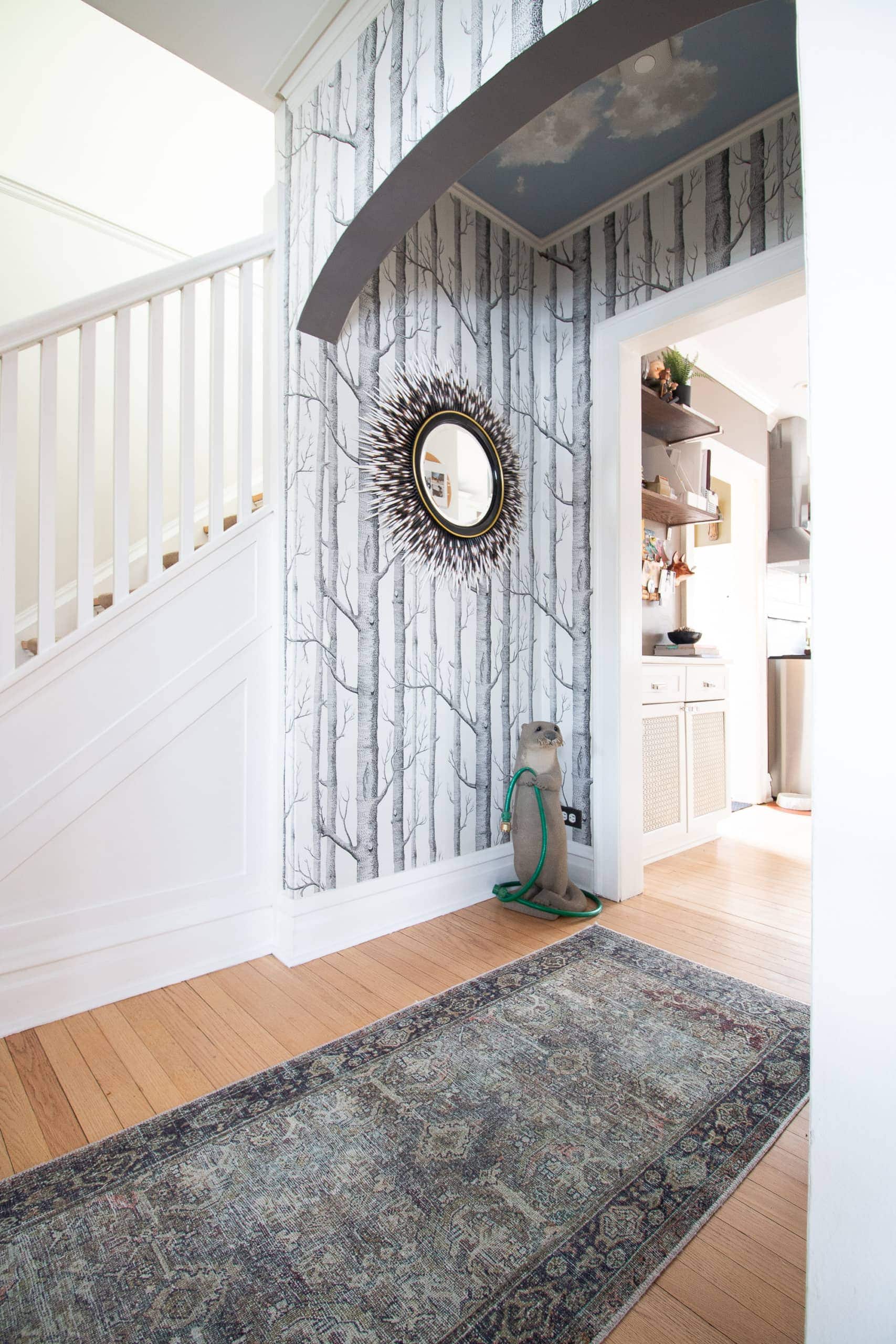 tree wallpaper in this whimsical home with unique accents