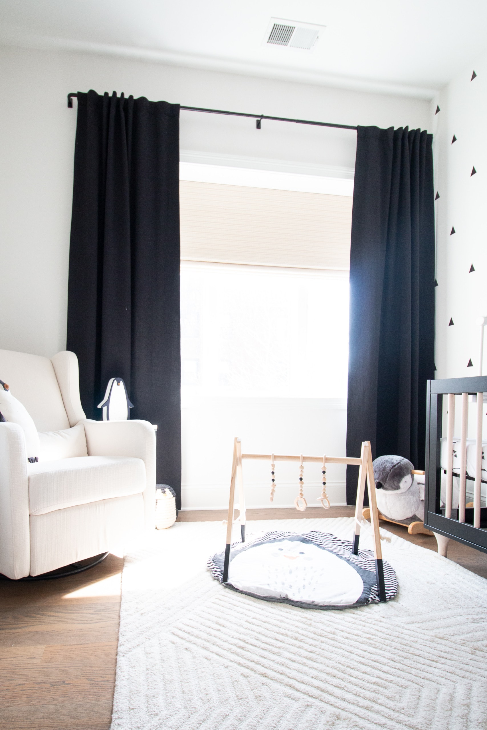 black curtains in a black and white themed nursery