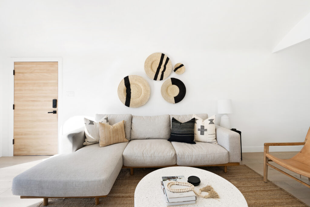 A white sectional with fiber art
