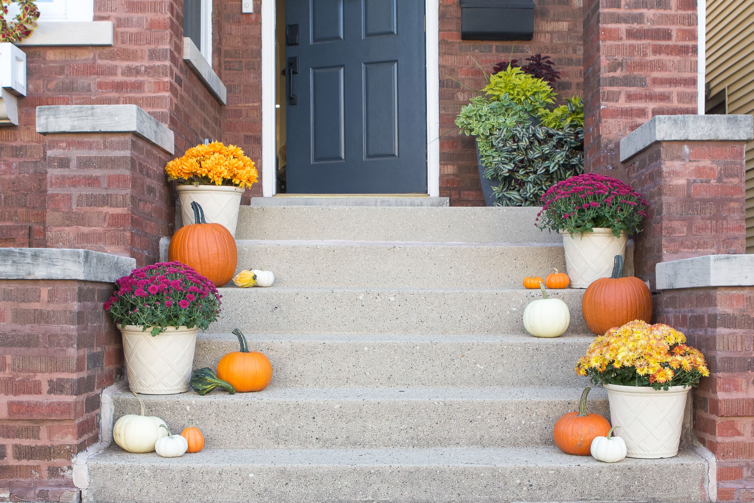 Our fall front porch with faux mums