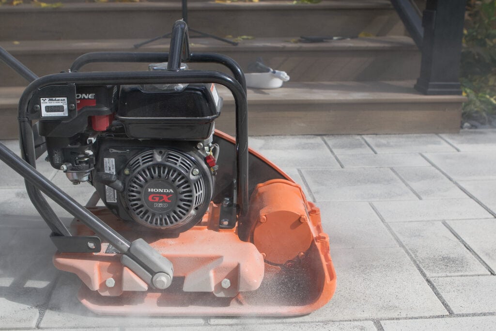 How to use a vibratory plate compactor to install polymeric sand