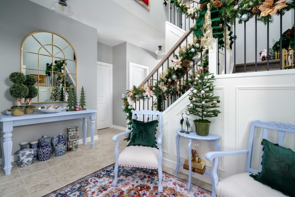 A holiday entryway with green accents and beautiful garland