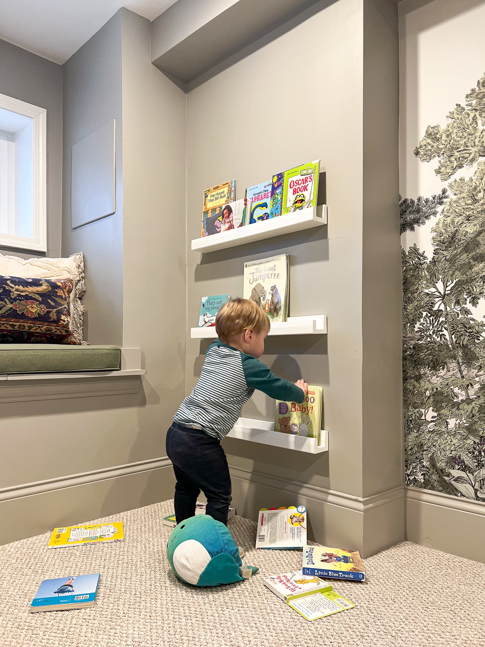 Ellis using the reading nook and book ledges