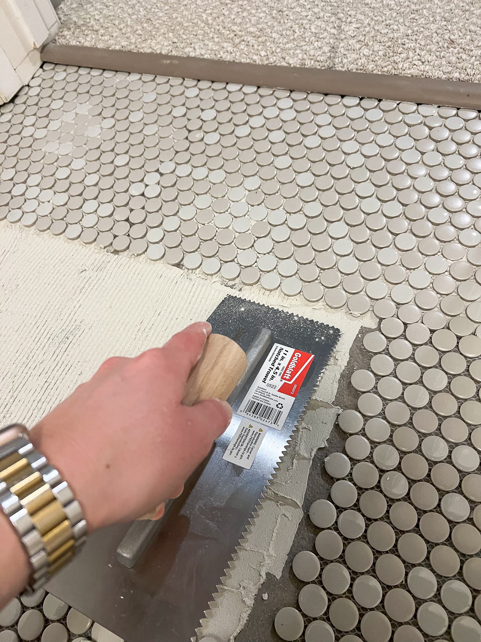 Using a notched trowel to install penny tile