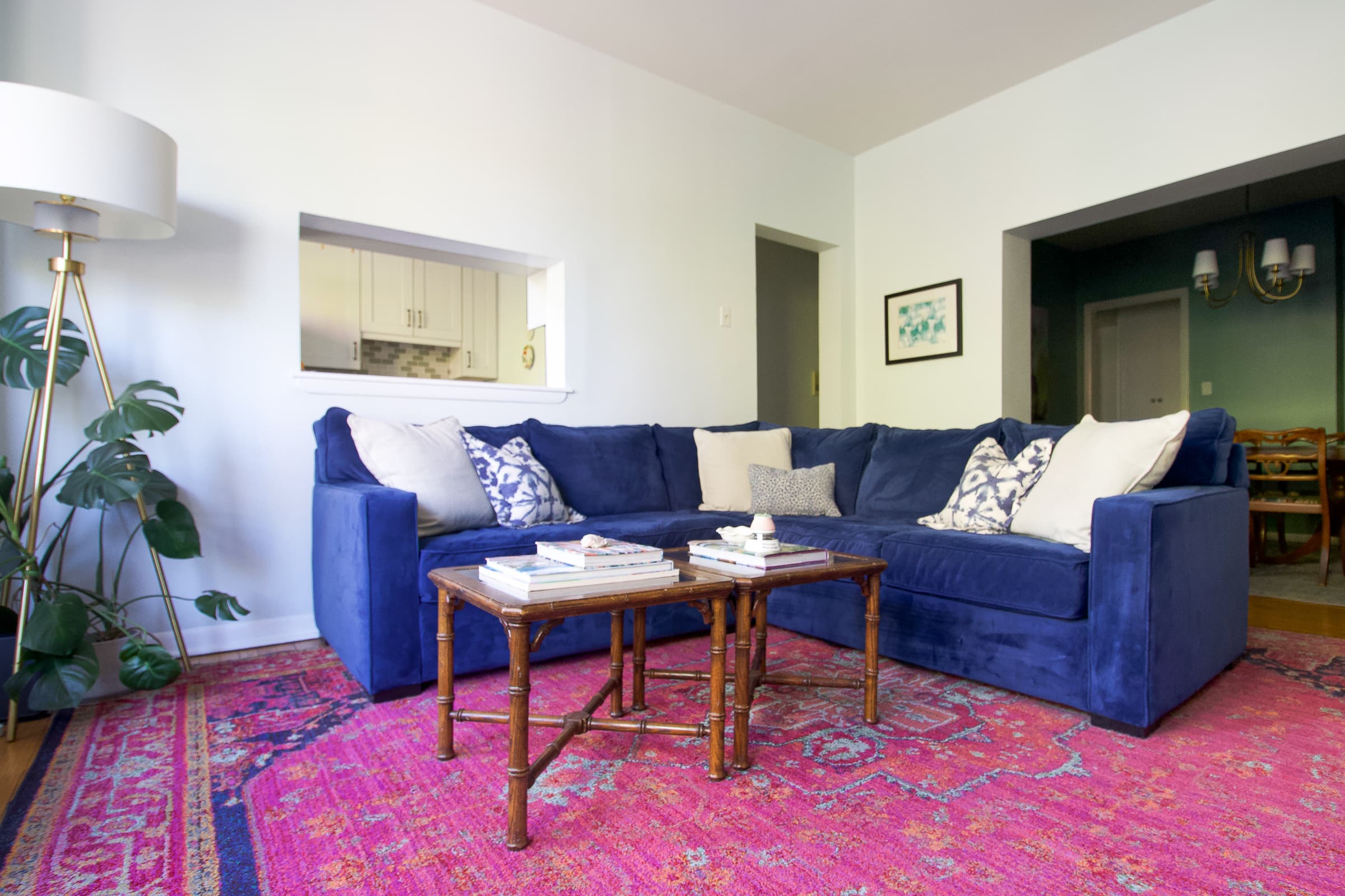 A navy living room couch in this colorful condo