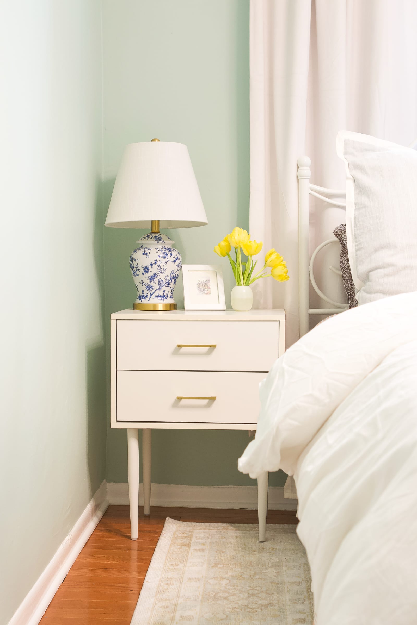 A white nightstand in a bedroom