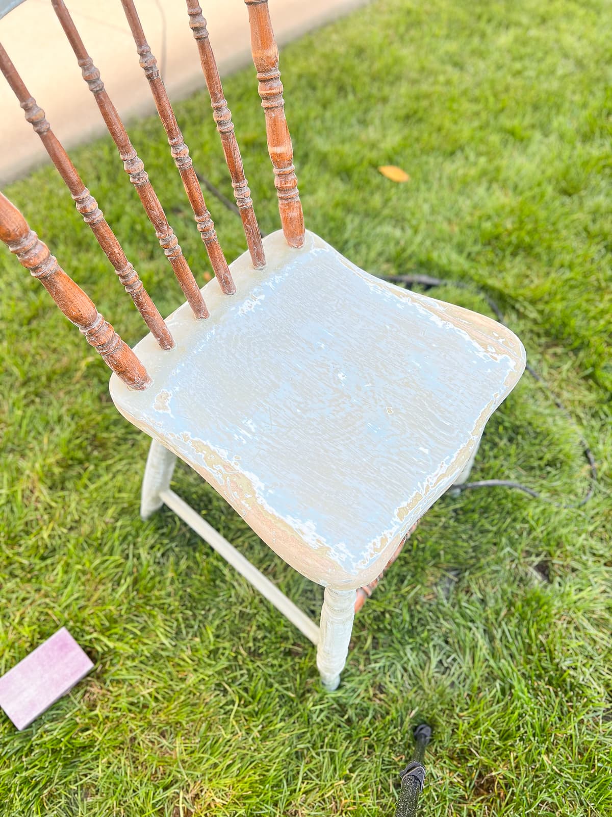 Sanding down an old chair to prep it for chalk paint