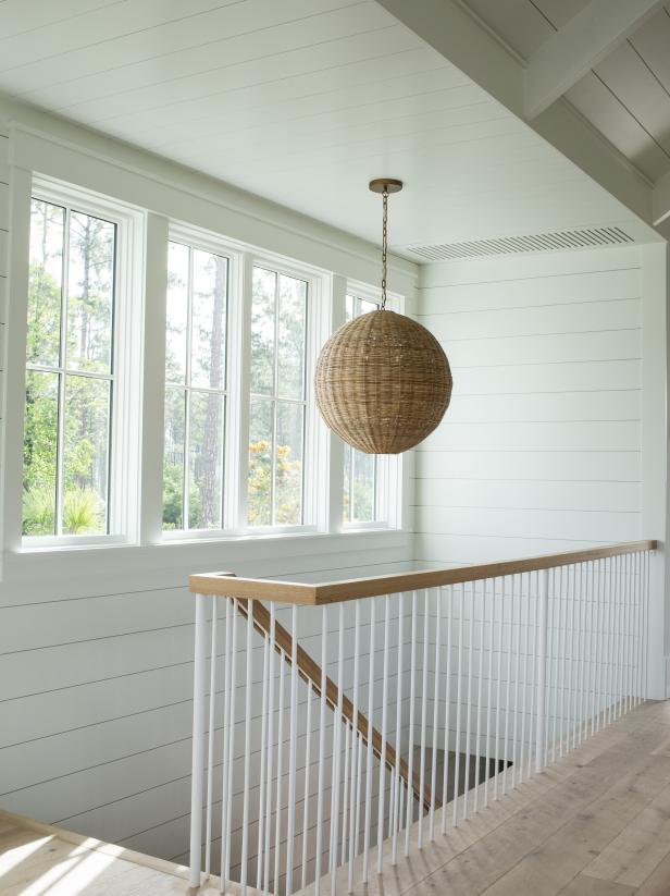 white spindles and white oak handrail in a beachy stairwell