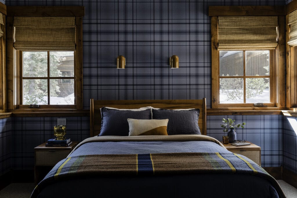 Plaid wallpaper that is blue in a bedroom with cabin feel