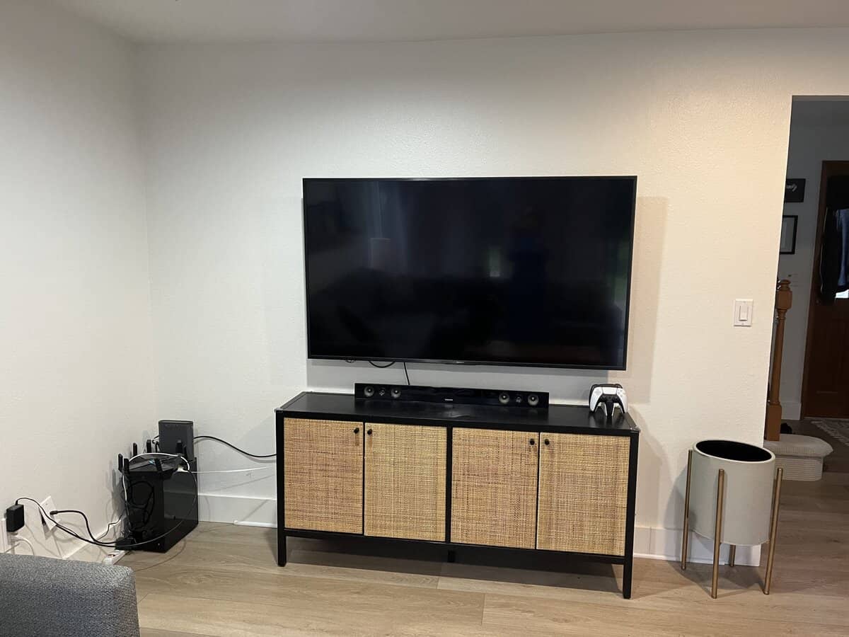 cords in a corner near a TV