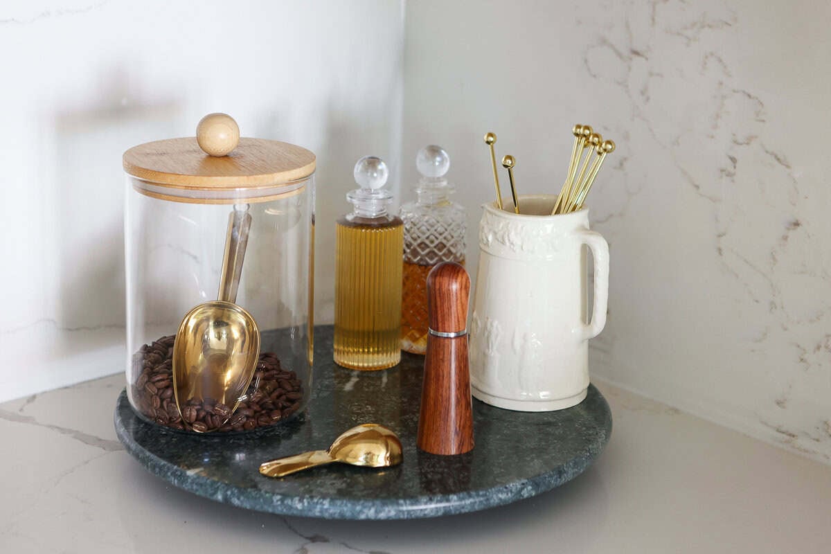 A green marble lazy susan to hold coffee accessories
