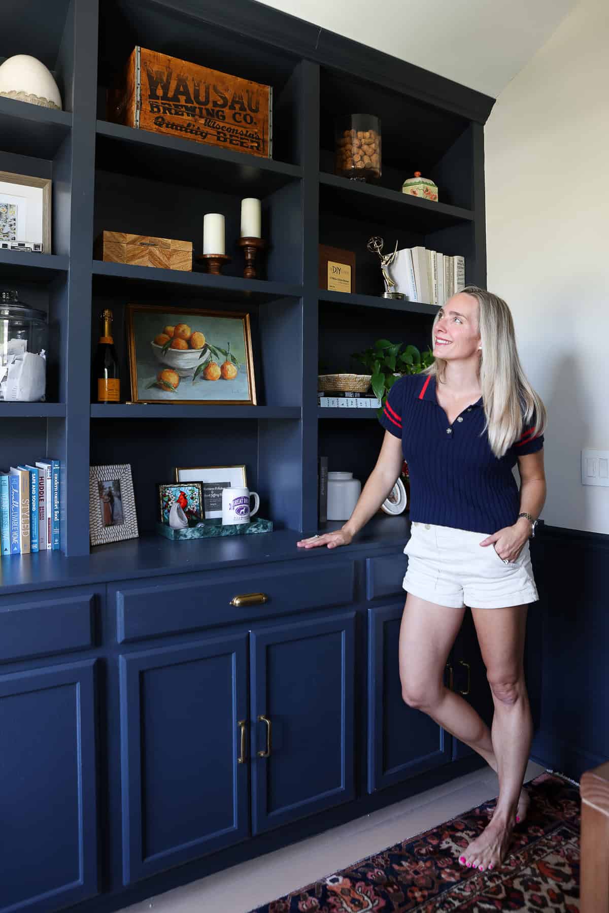 navy blue built-ins with books and decor
